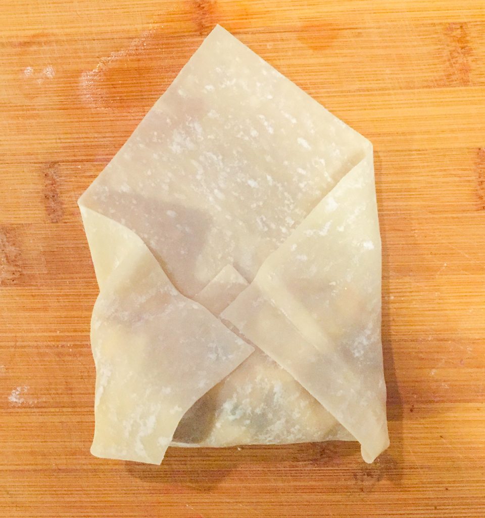 how-to-make-ackee-and-saltfish-springrolls-step-3-fold-up-bottom-of-square-and-fold-in-both-sides-of-the-egg-roll-wrapper